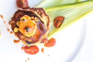BACON CORN CAKES WITH SORGHUM SYRUP & TOMATO CHILE BUTTER