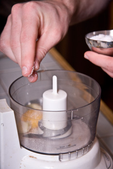 adding ingredients to a food processor