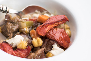LAMB STEW WITH RAS EL HANOUT CASHEW CREAM, SLOW ROASTED TOMATOES & FRIED CHICKPEAS