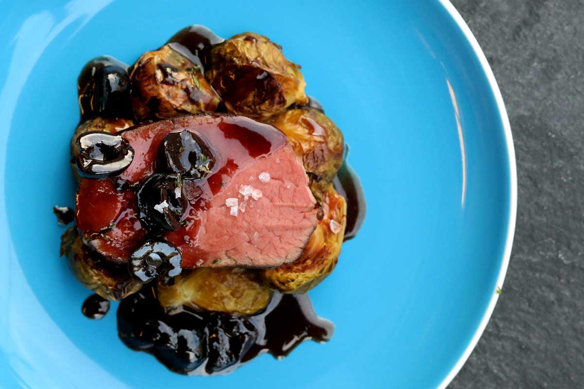 Roast bison tenderloin with roasted brussels sprouts & cherry port sauce
