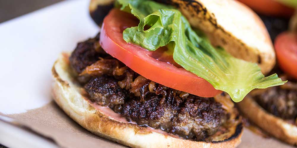 Grass-fed Burgers with Cornichon Sauce, Artisan Cheddar & Caramelized Onions