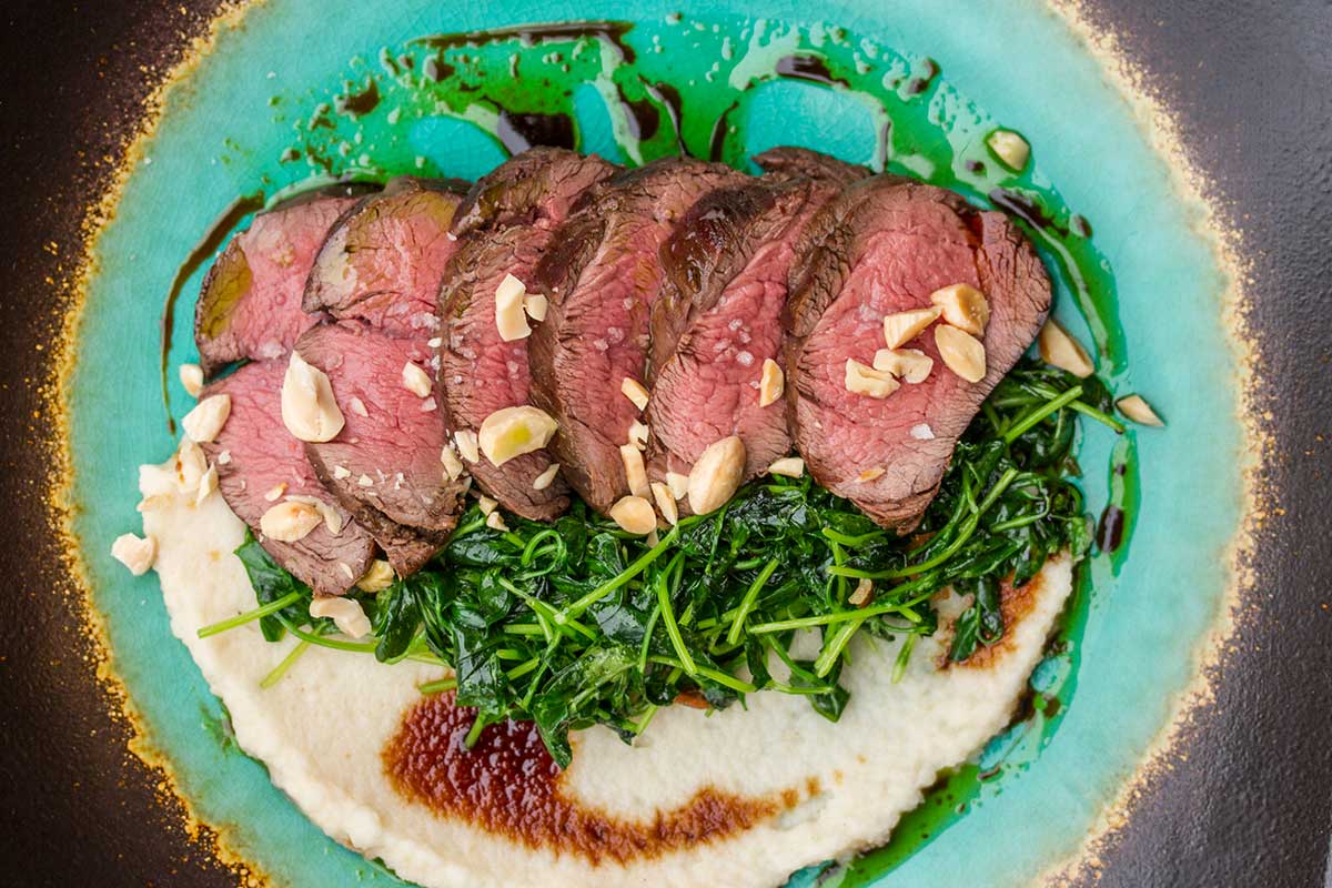Venison Tenderloin with Brown Butter Celery Root Puree & Wilted Pea Shoots